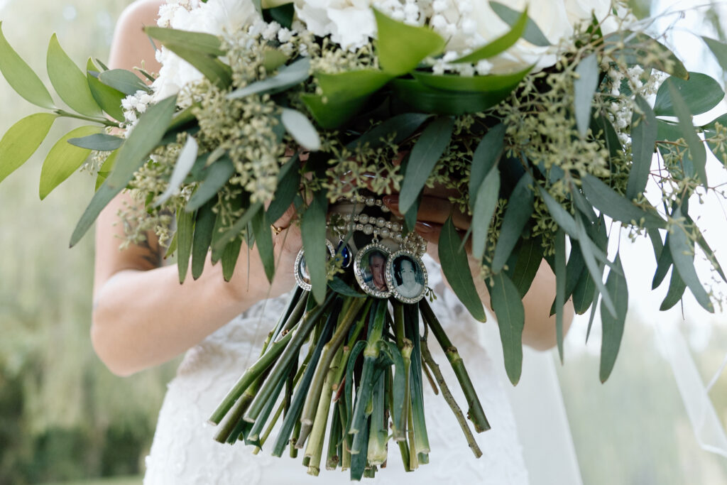 Bride holds bouquet with photos of loved ones