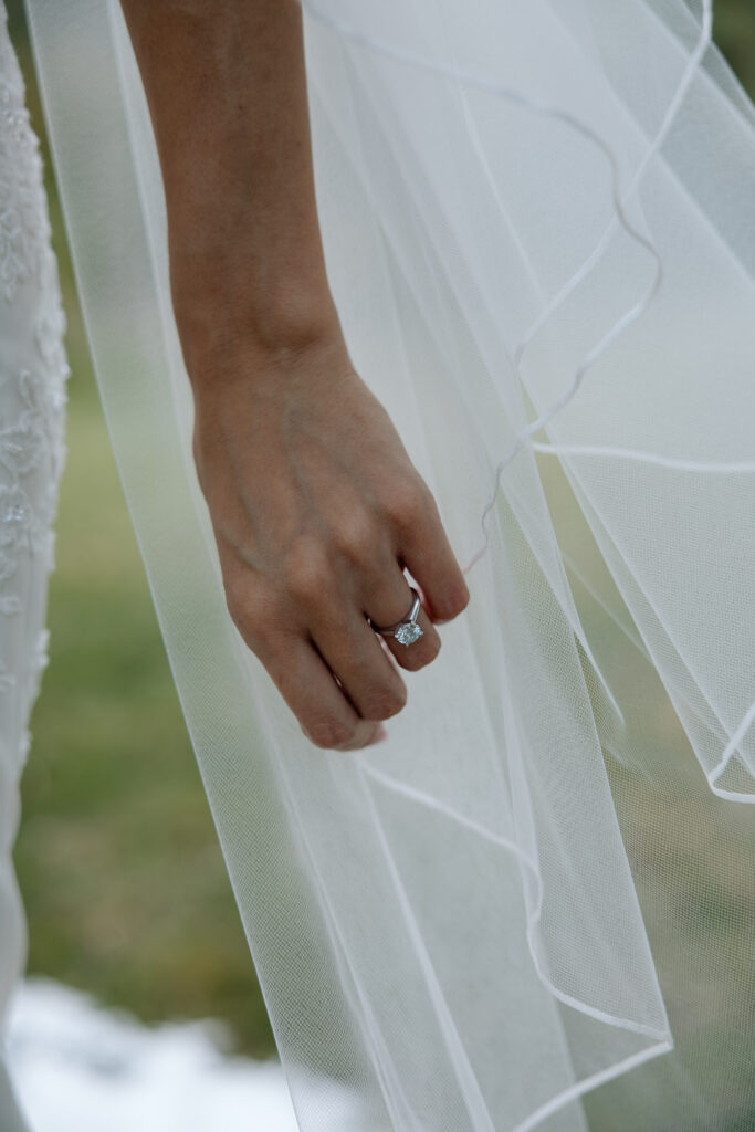 Bride shows wedding ring outside