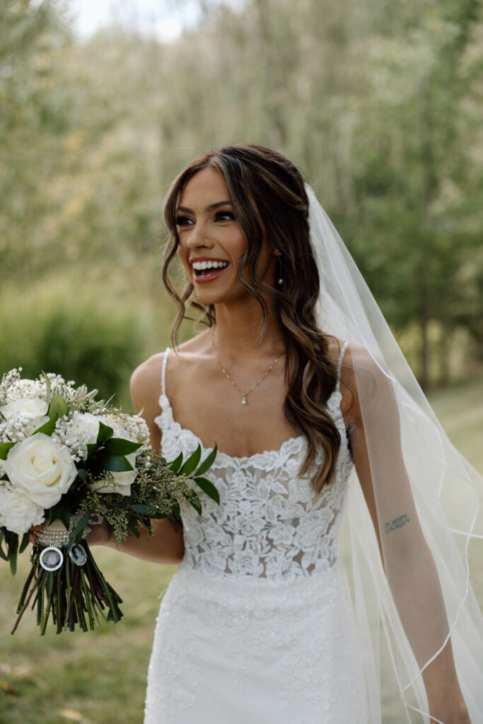 Bride wears veil outside wedding