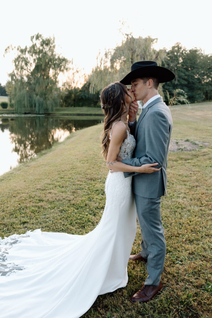 Bride and groom kiss in rustic wedding venue