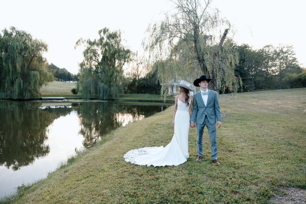 Couple look out across the lake after wedding ceremony