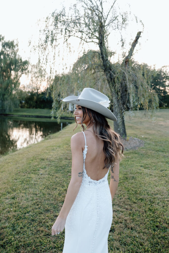 Bride smiles gazing out at intimate outdoor wedding space