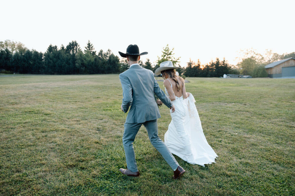 Bride and groom wear cowboy hats in intimate wedding