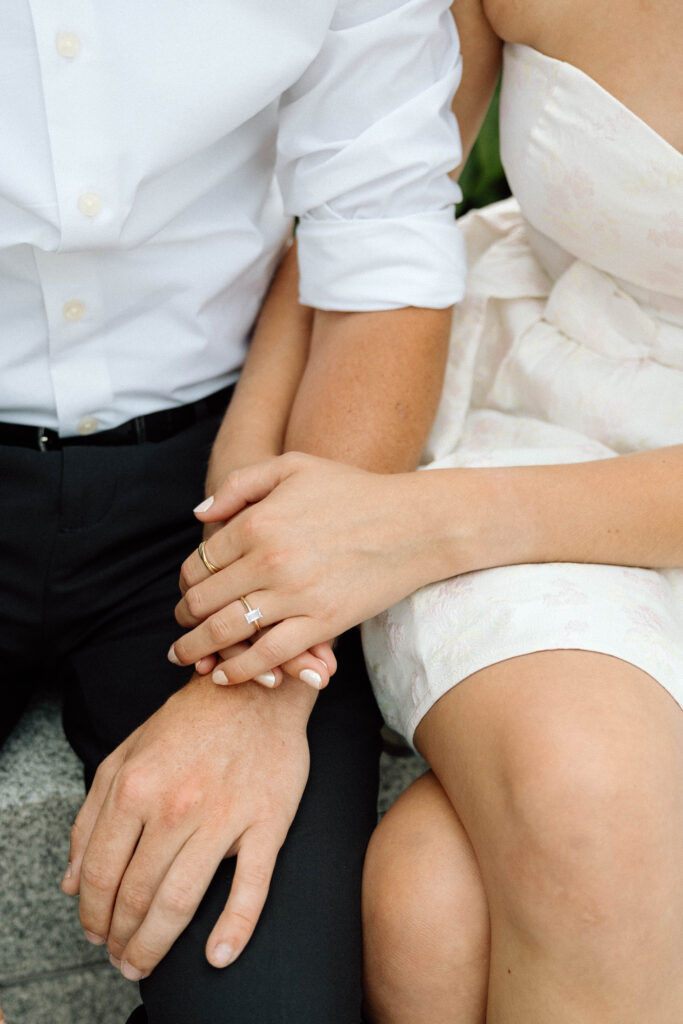 Engagement ring shines as couple holds hands luxury engagement photos