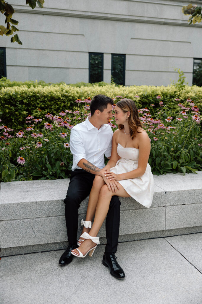 Engaged couple lock eyes and hold hands at the Pennsylvania State Capitol