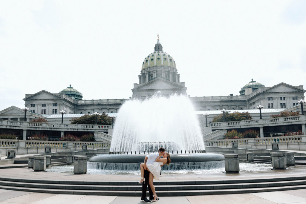 Engaged couple kiss at the Pennsylvania State Capitol luxury engagement photos