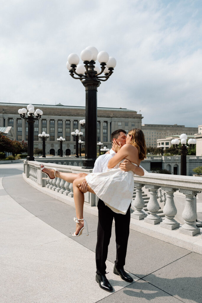 Engaged man holds woman and spins