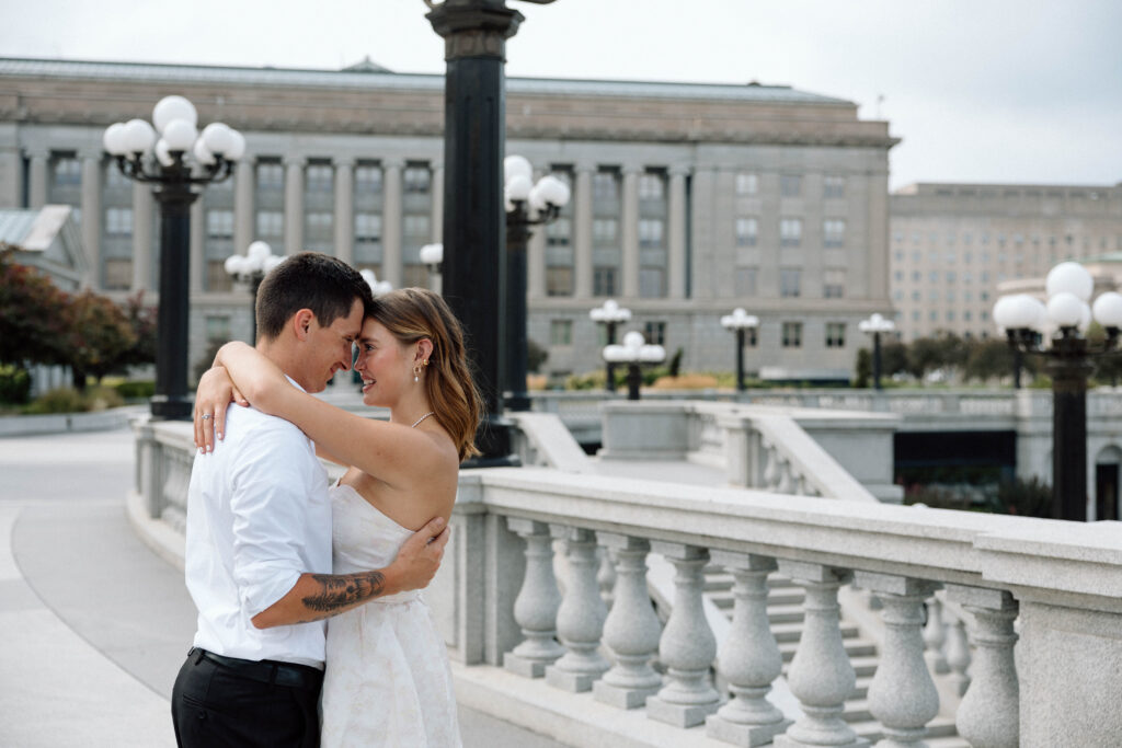 Couple hug and smile at the Pennsylvania Capitol Complex luxury engagement photos