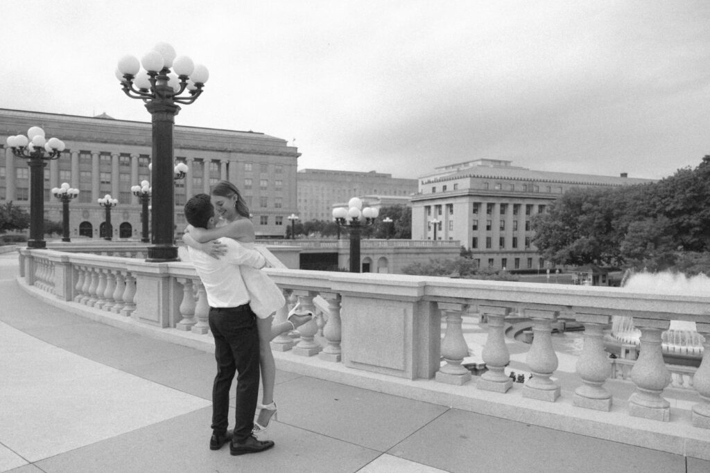 Engaged couple smile in bliss outside the Pennsylvania capitol complex