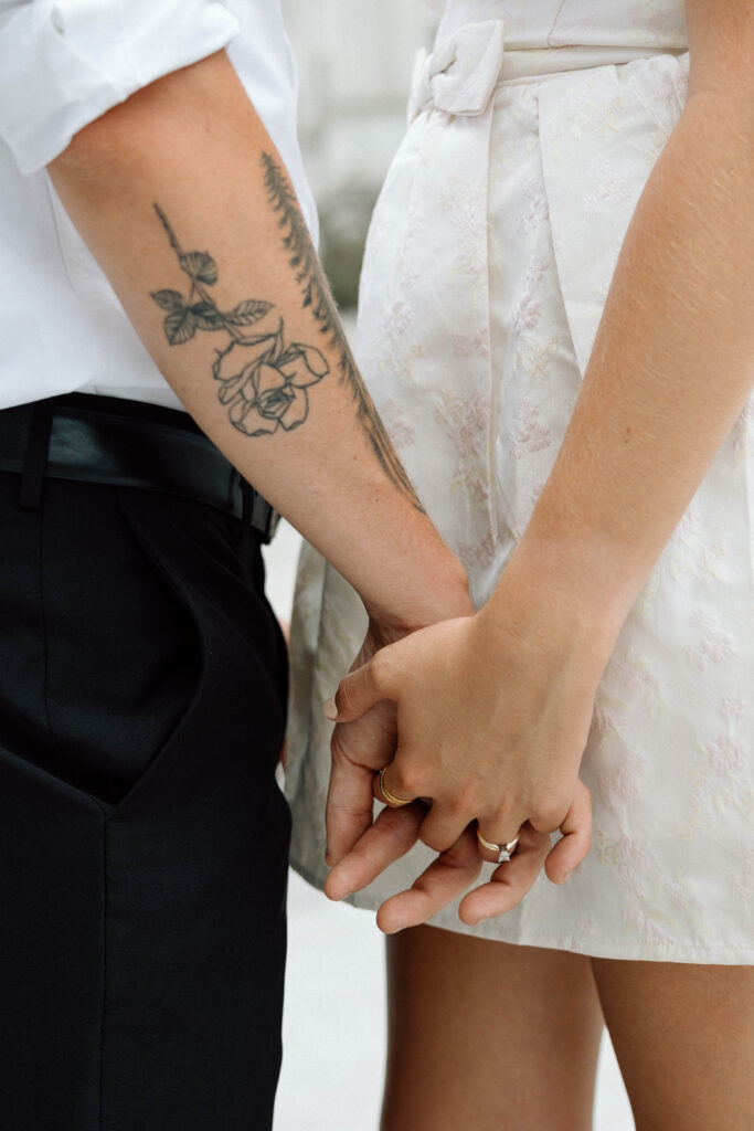 Man and woman are engaged and hold hands with their rings on