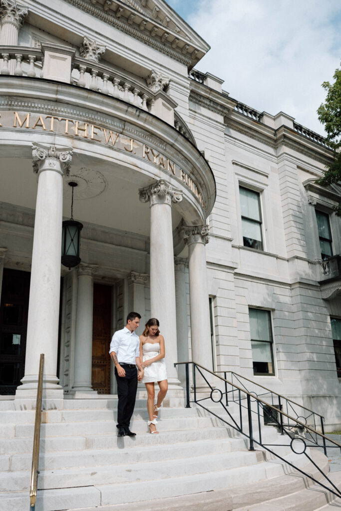 Couple descend the steps outside the capitol luxury engagement photos