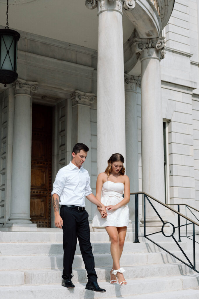 Couple walk down the steps of the Pennsylvania Capitol building luxury engagement photos