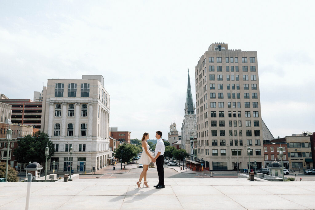 Couple holding hands in downtown Pennsylvania, one of their engagement photo locations.