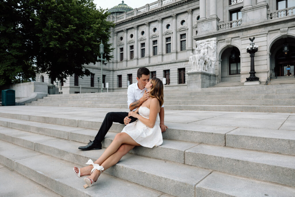 Pennsylvania couple kiss on the capitol building steps luxury engagement photos