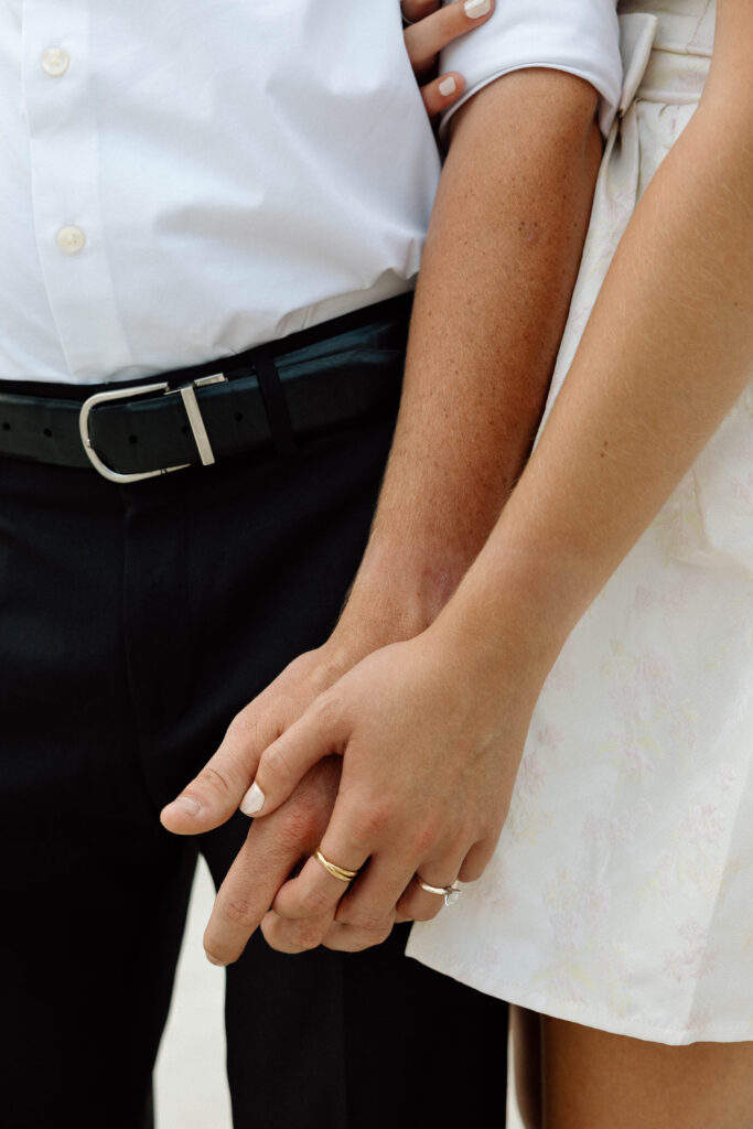 Engaged couple hold hands