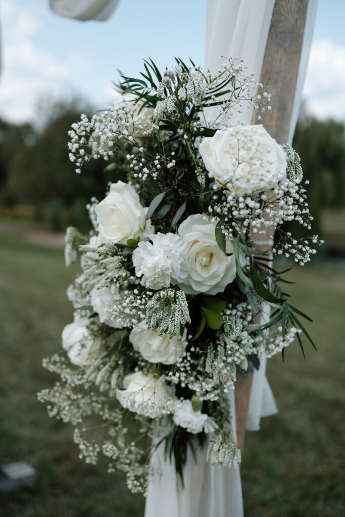 White flowers decorate outdoor wedding