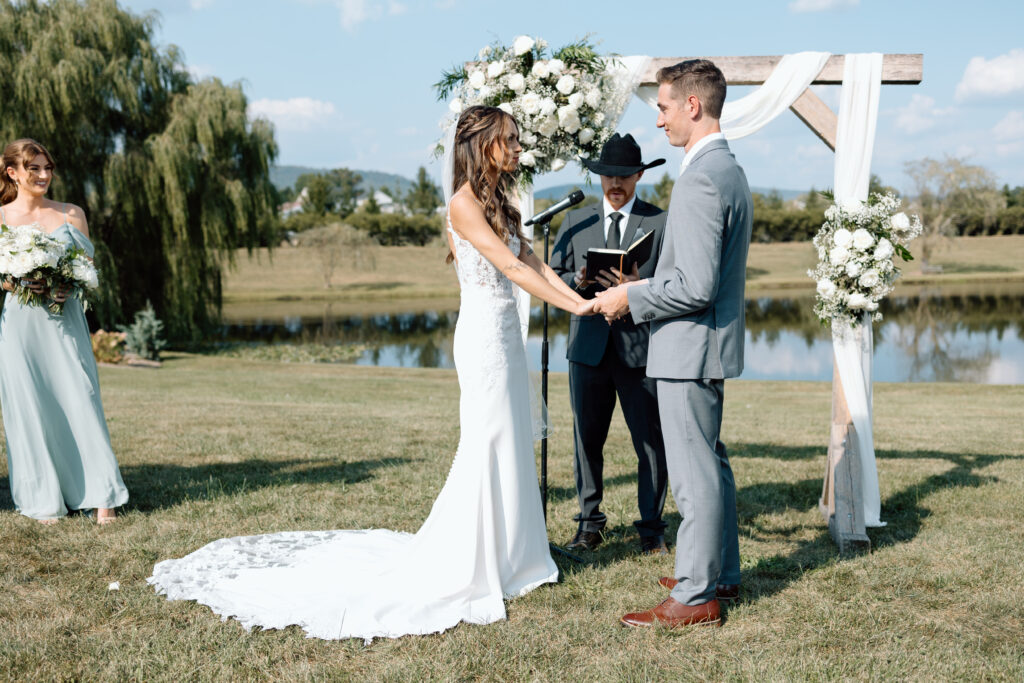 Bride and groom hold hands and take vows at Pennsylvania wedding venue outdoors