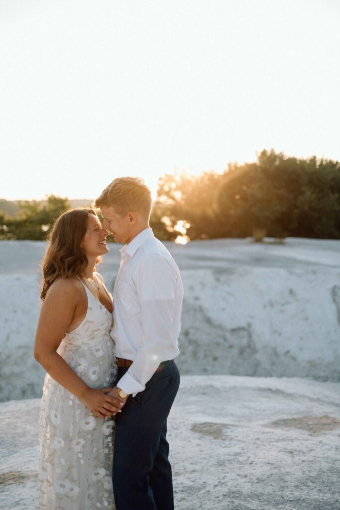 A couple holding each other at sunset at the White Cliffs of Conoy captured by their engagement photographer. 