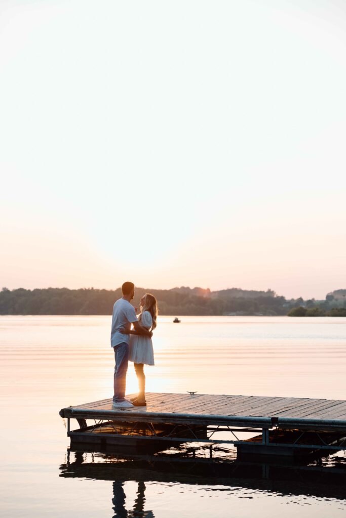 Couple on a dock at sunset at Cordorus State Park captured by an engagement photographer.