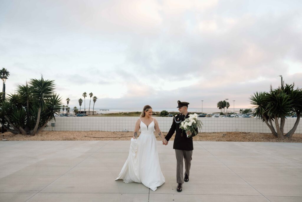 Newlyweds walking hand in hand after their intimate wedding in San Diego.