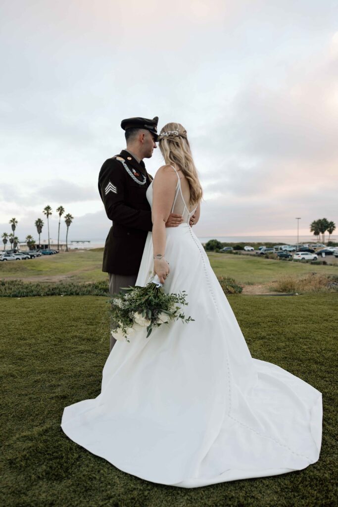 Bride and groom looking towards the coast.