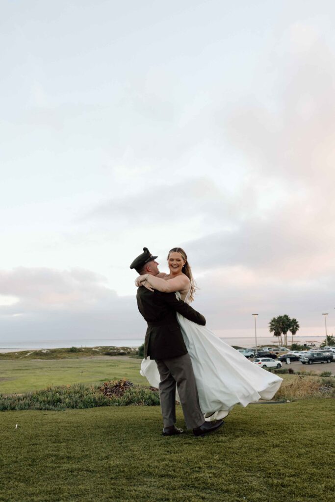 Bride and groom spinning and smiling after their wedding in San Diego.