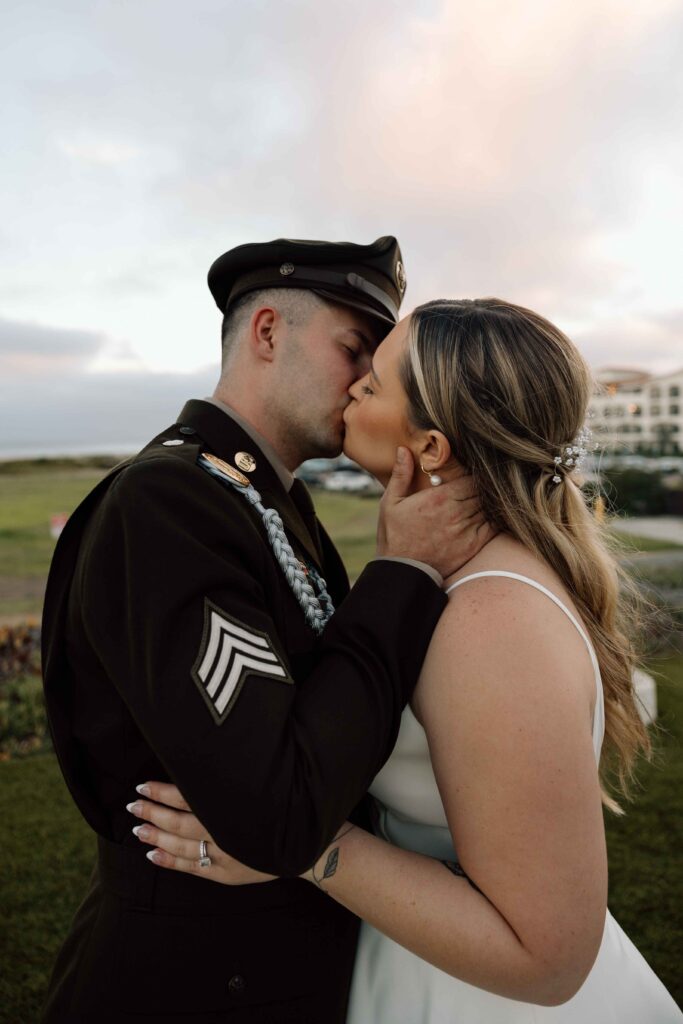 Married couple kissing at sunset.