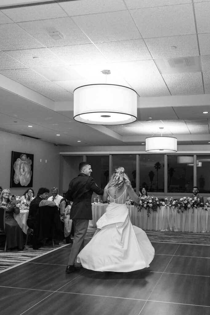 Bride and groom dancing and spinning for their guests at their wedding in San Diego.