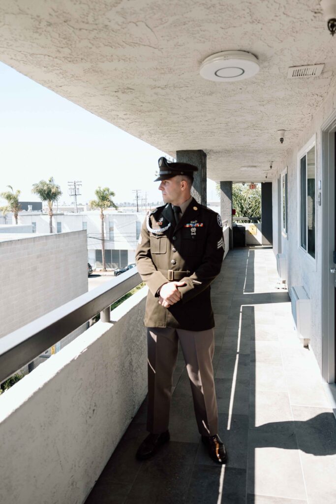 Groom portraits looking off into the distance, dressed and ready in his military uniform.