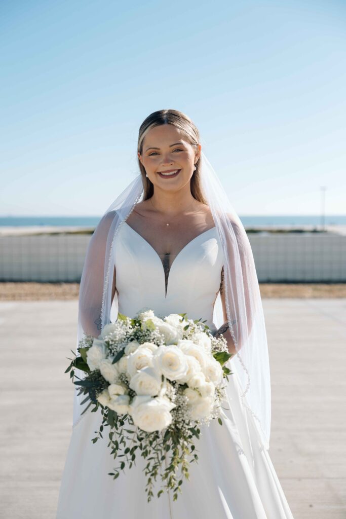 Bride holding a beautiful flower bouquet during her wedding pictures. 