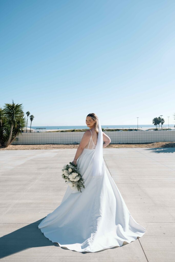 Bride looking back over her shoulder towards her destination wedding photographer.