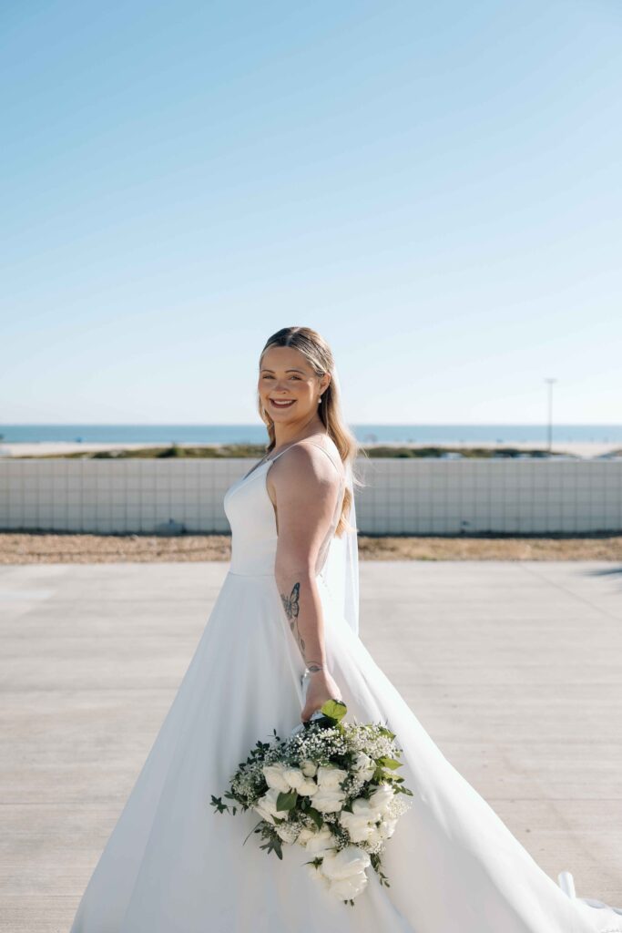 Bride posing for her destination wedding photographer before her wedding in San Diego.