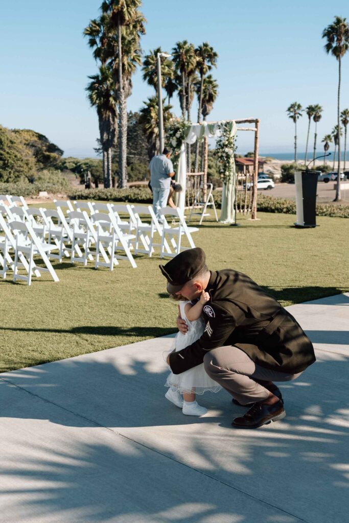 Groom hugging his daughter before his wedding in San Diego.