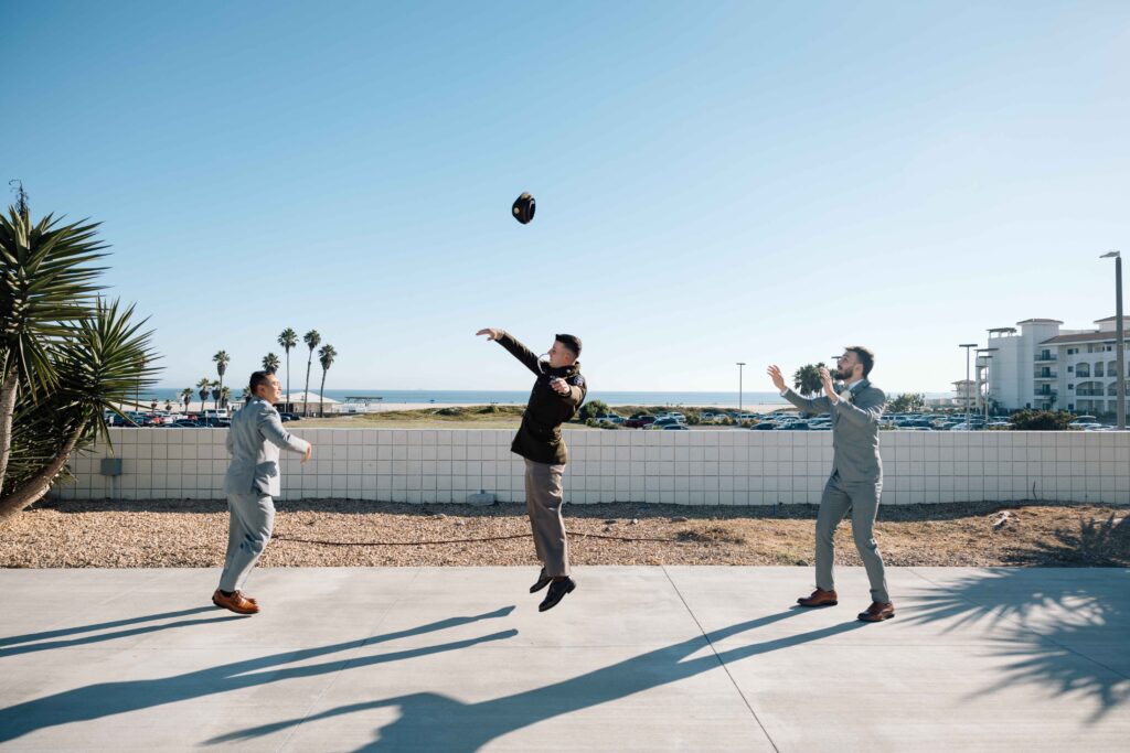 Groom and his bed men playing monkey in the middle before the wedding in San Diego.