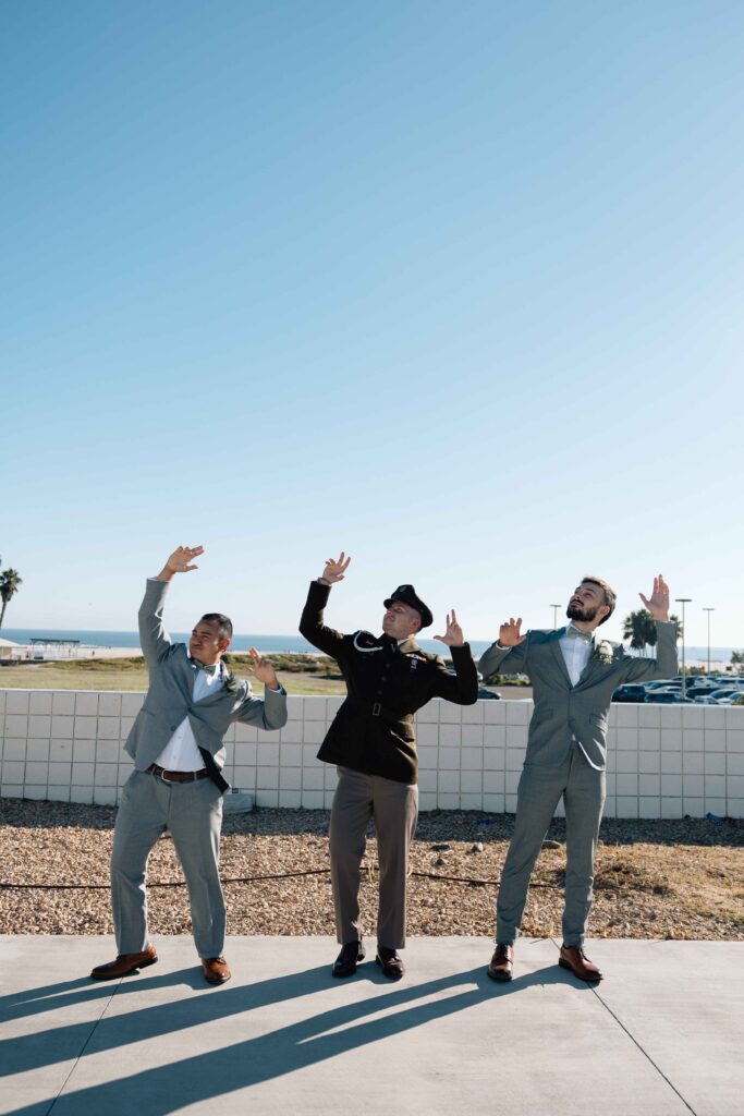 Groom and his groomsmen making a silly pose.