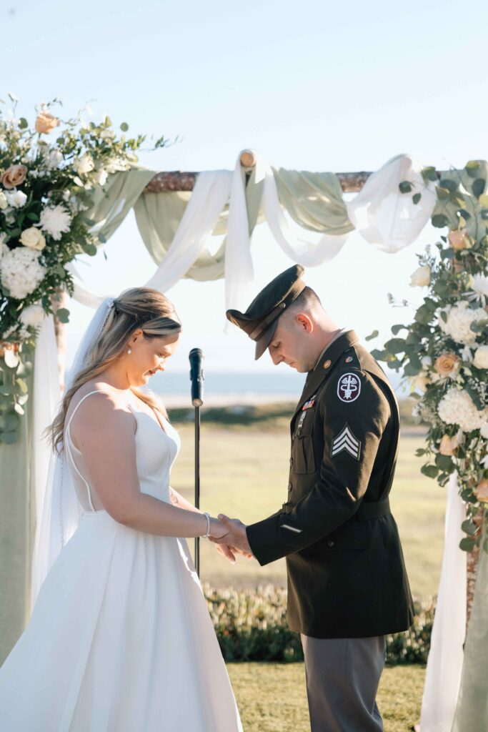 Bride and groom praying at the altar.