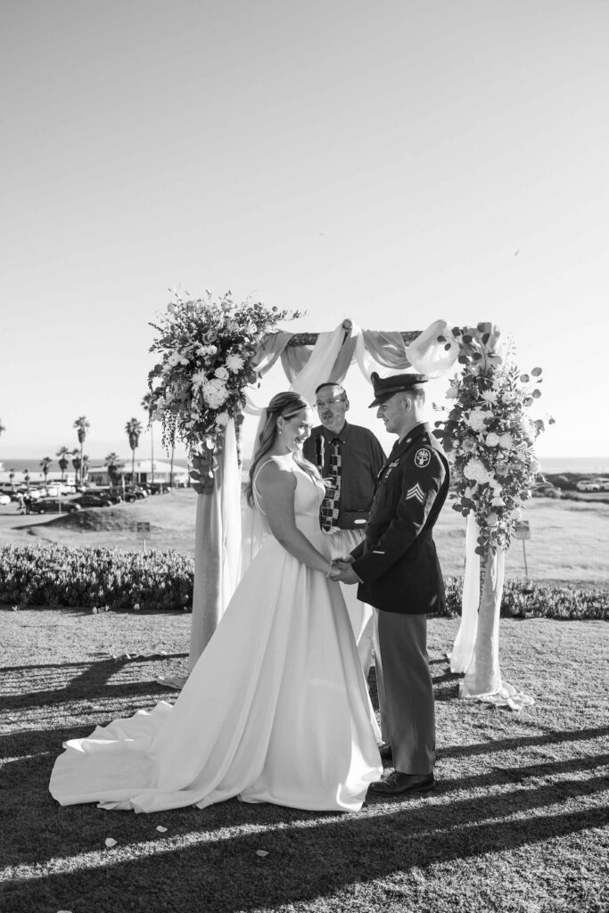 Bride and groom holding hands at the altar.