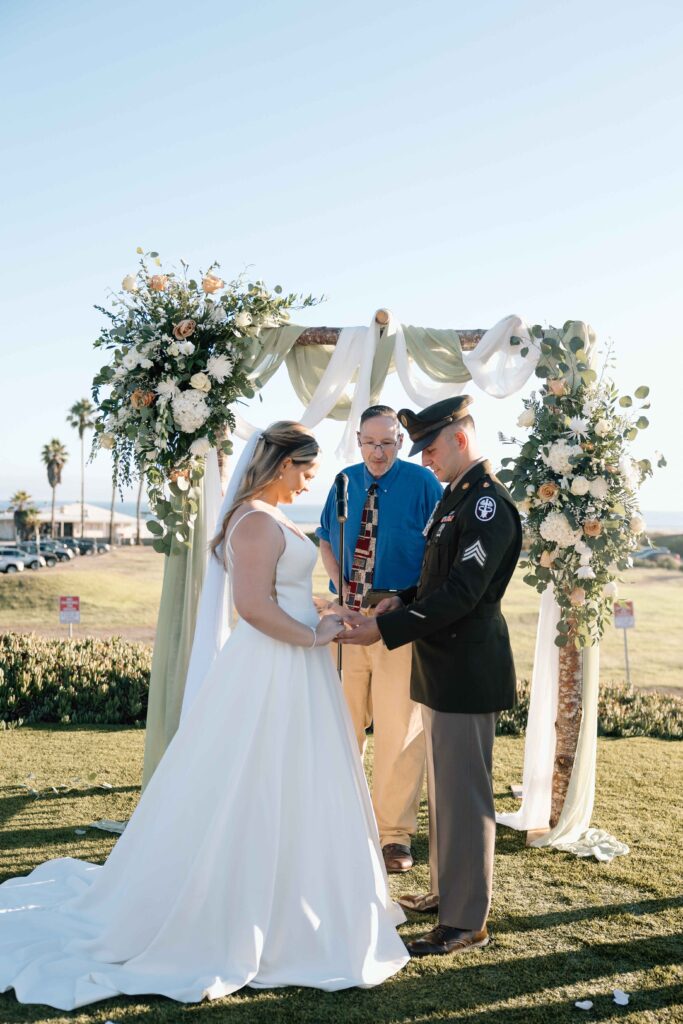 Bride and groom exchanging rings during their intimate wedding wedding in San Diego.