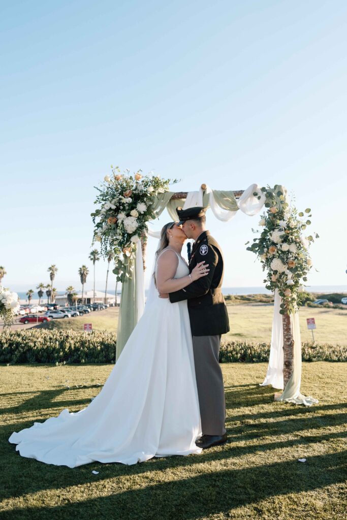 Bride and groom kissing after saying "I do" at their wedding in San Diego.