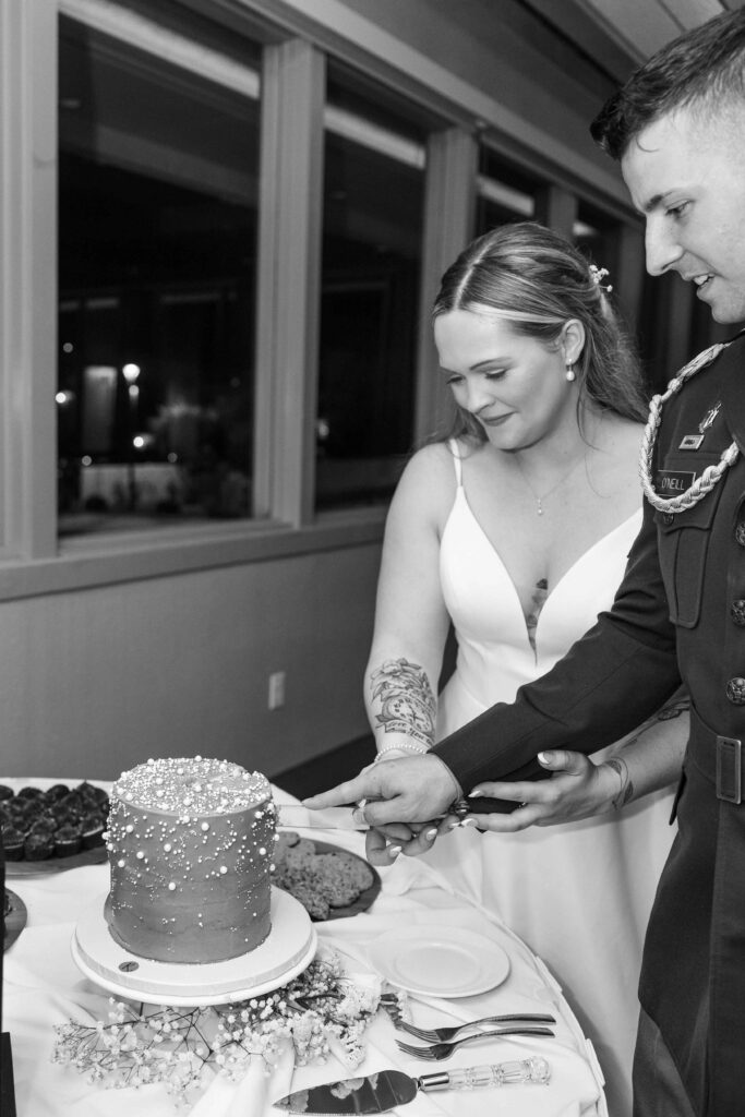 Newlyweds cutting cake at their wedding in San Diego.