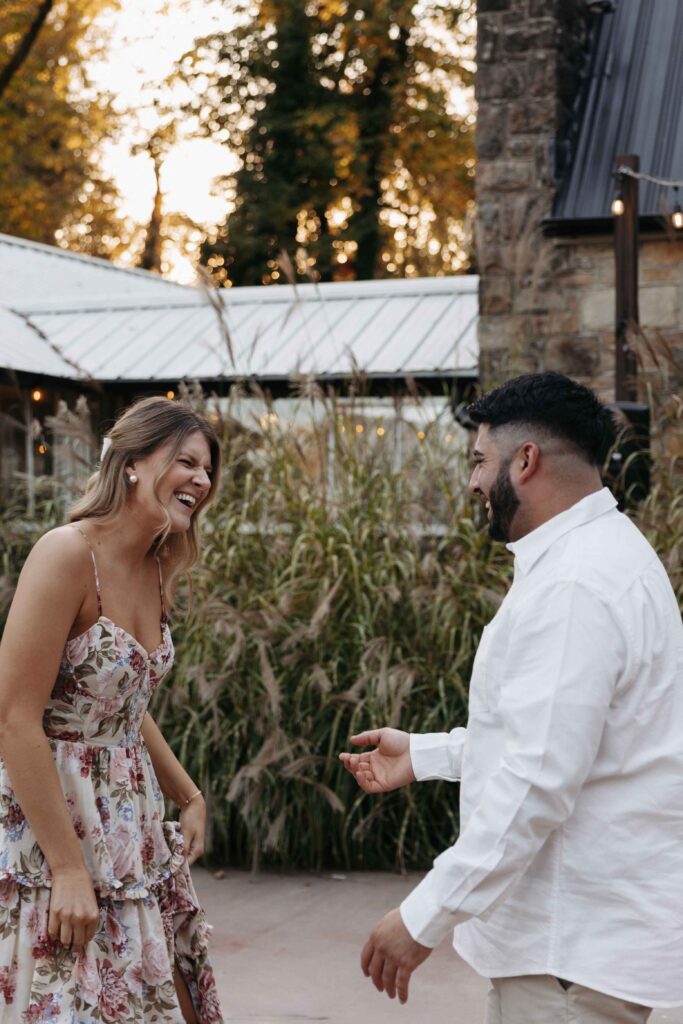 Couple laughing during their playful engagement photoshoot. 