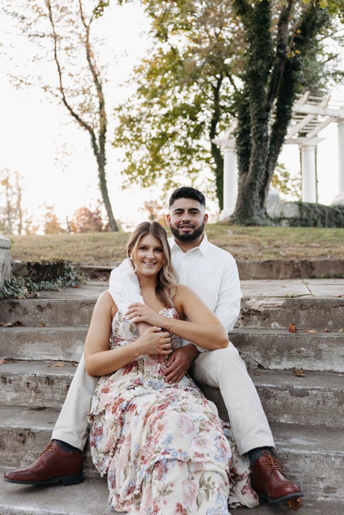 Couple embracing on the steps at Historic Shady Lane. 