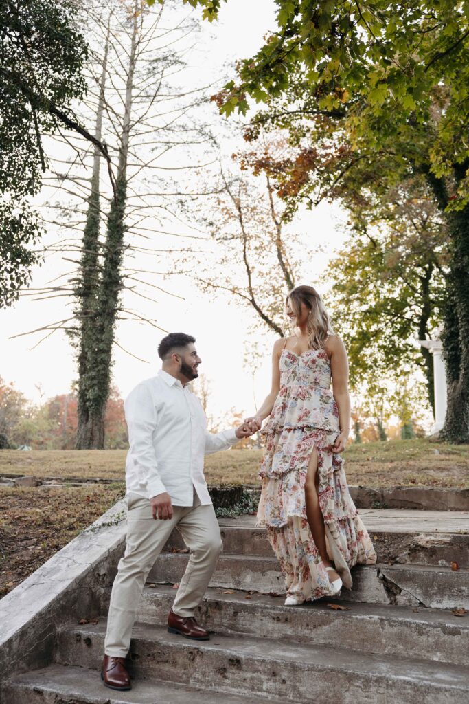 Couple posing on the steps for their engagement photoshoot. 