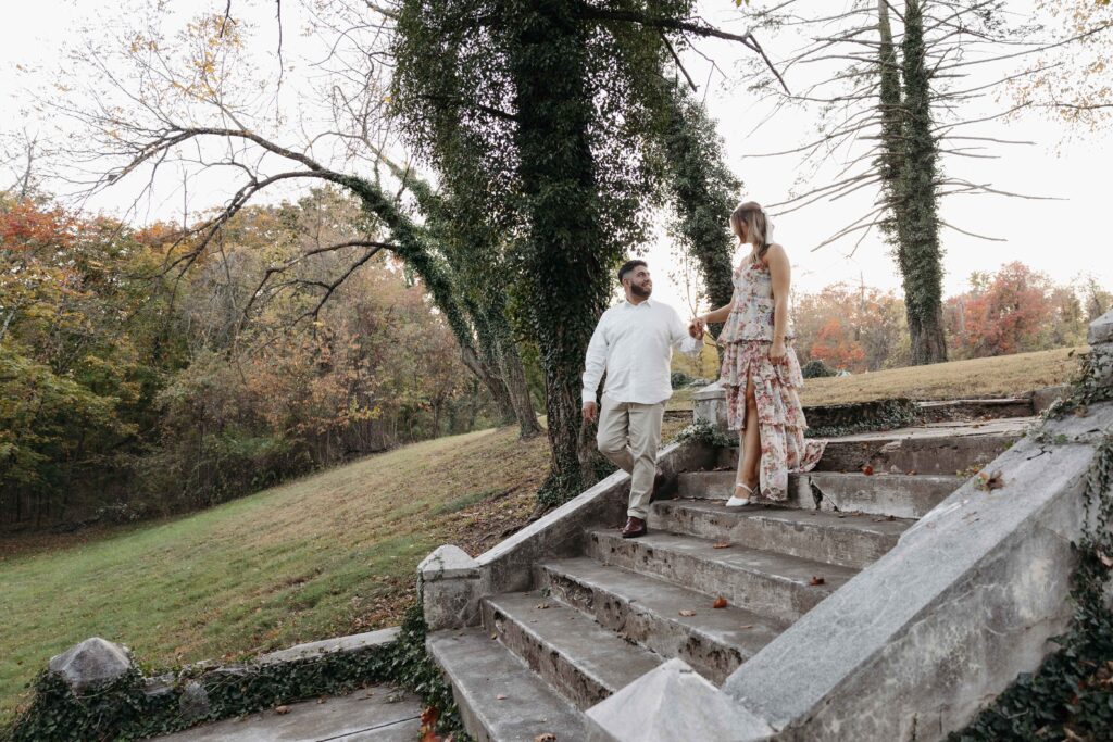 Couple walking down stairs looking at each other in love.