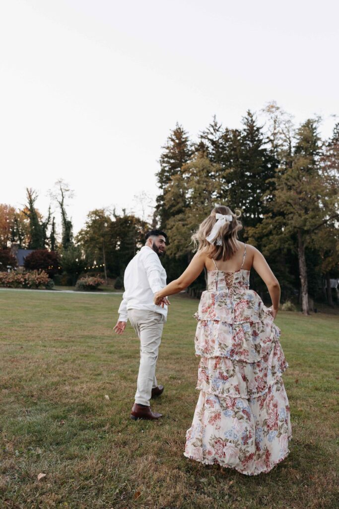 A couple playfully running around at Historic Shady Lane. 