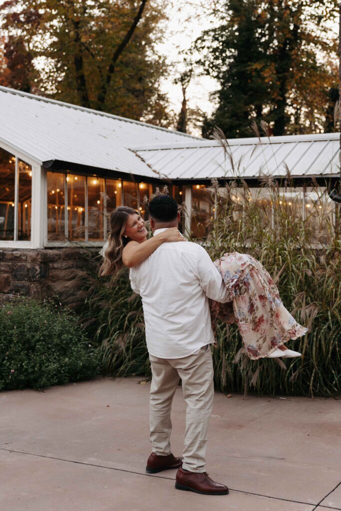 A man holding his fiancee in his arms. 