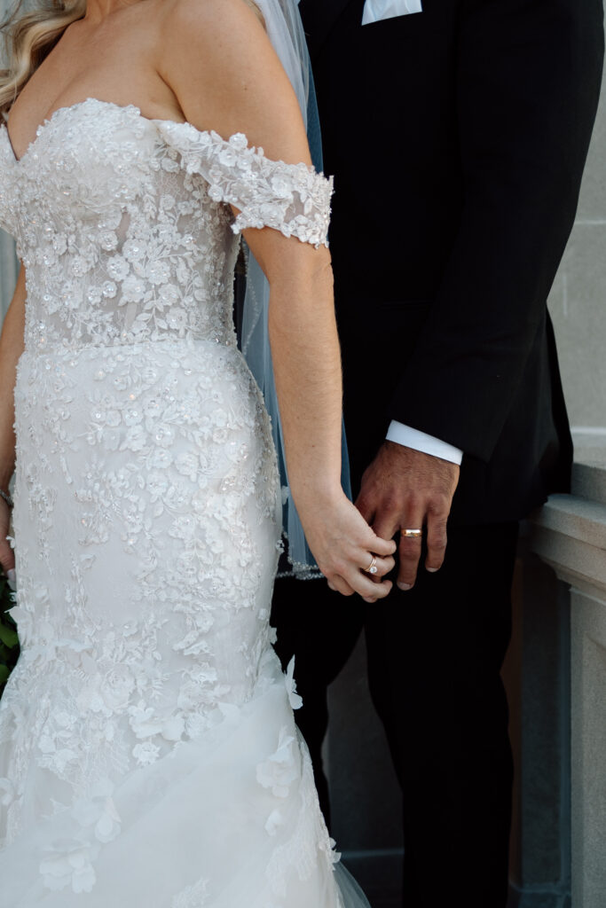 Close up of bride and groom outfit details.