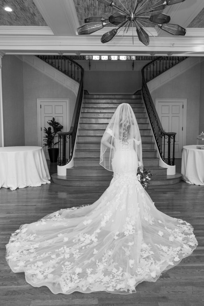 Elegant wedding photos of the bride from behind, showing off her long gown.