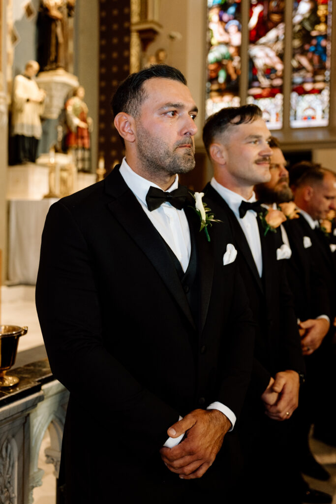 The groom tearing up as he sees his bride walk down the aisle. 