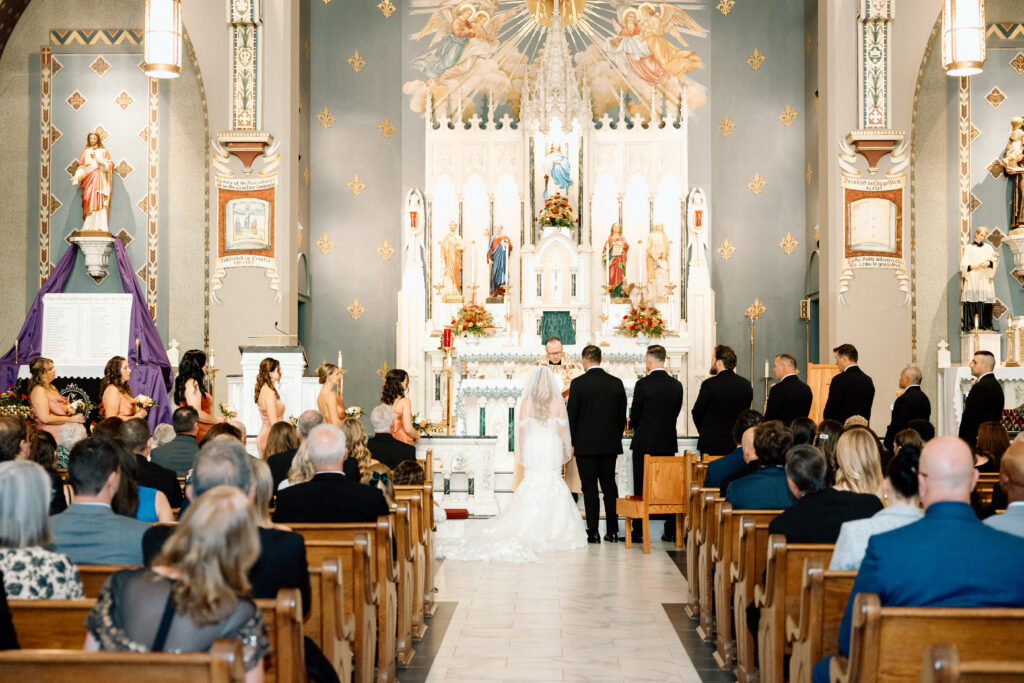 The bride and groom and wedding party standing at the altar during their church wedding ceremony in PA.